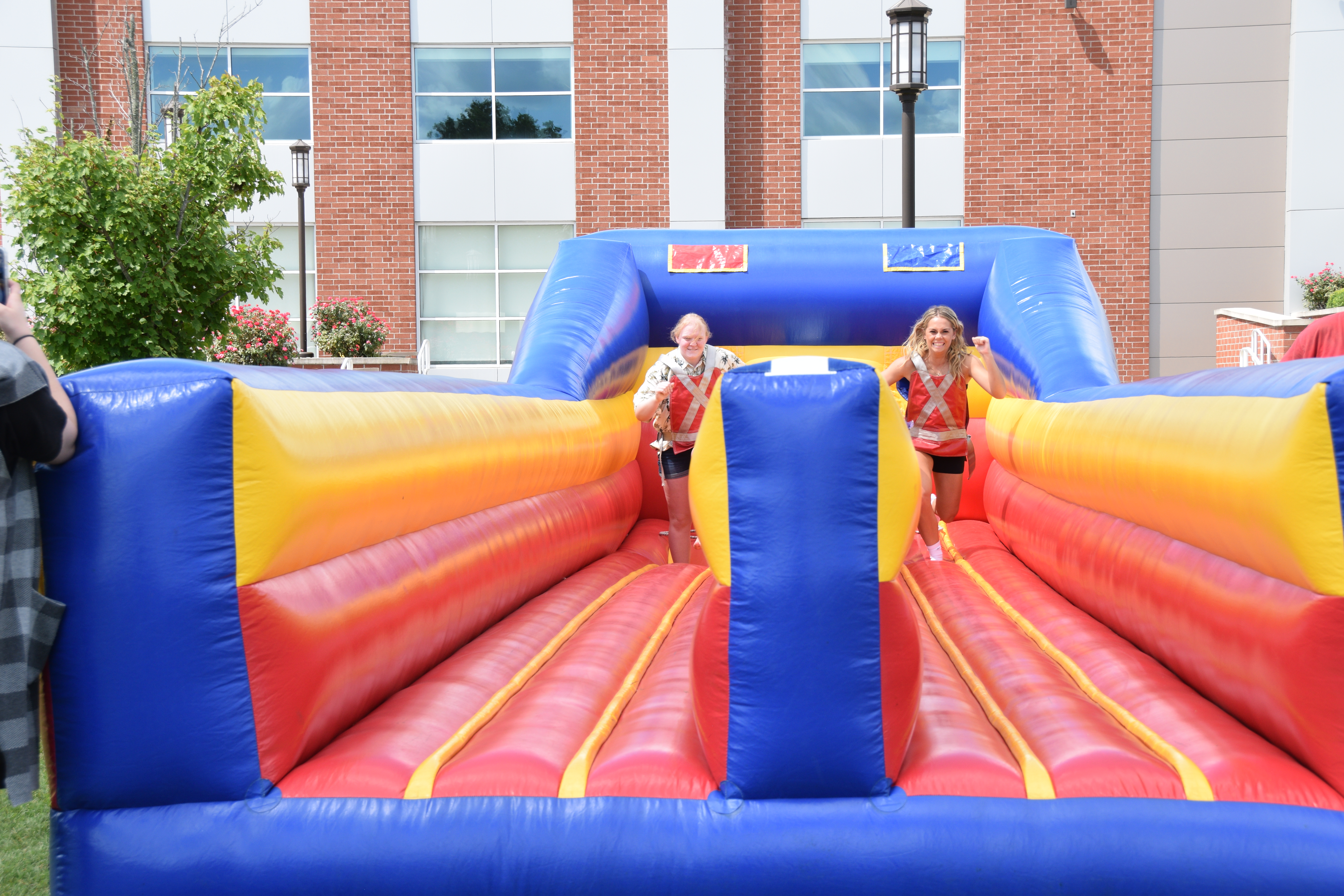 Two VU students strapped in and enjoying an inflatable bungee run